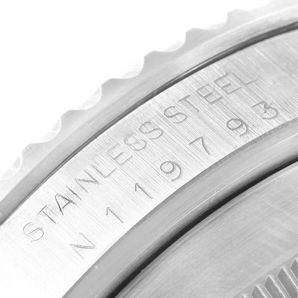 This image shows a close-up view of the engraved stainless steel bezel on a Rolex Submariner 14060 Men's Stainless Steel Black Dial 14060 Men's Stainless Steel Black Dial watch.