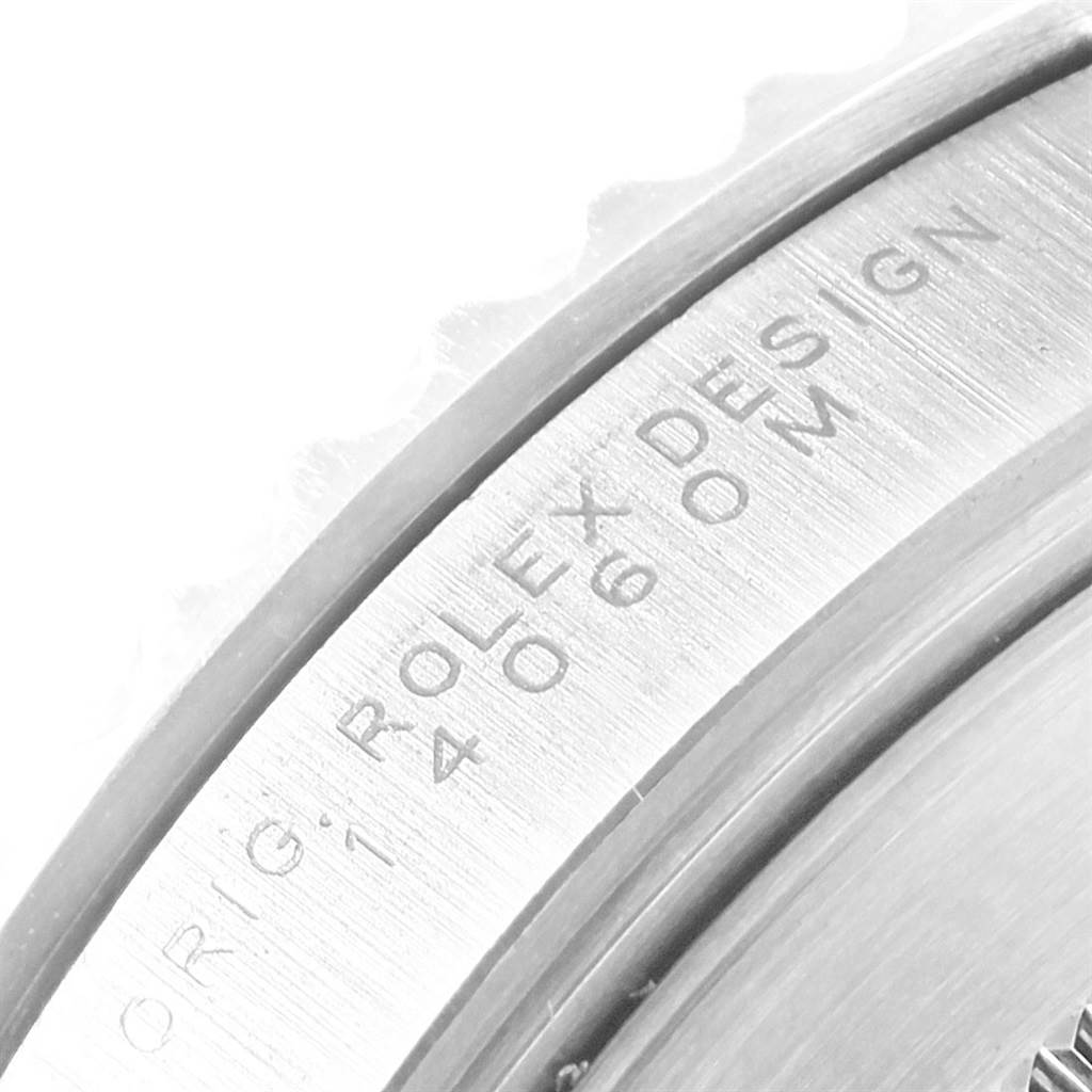 The image shows a close-up of the engraved edge on a Rolex Submariner 14060 Men's Stainless Steel Black Dial 14060 Men's Stainless Steel Black Dial watch casing.