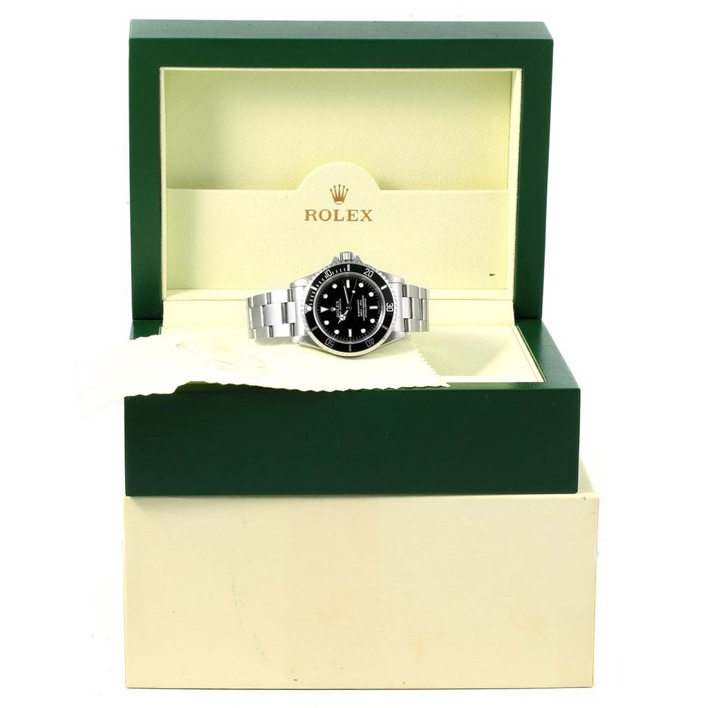 The Rolex Submariner 14060 Men's Stainless Steel Black Dial 14060 Men's Stainless Steel Black Dial watch is shown from a front angle in its open green and cream display box.
