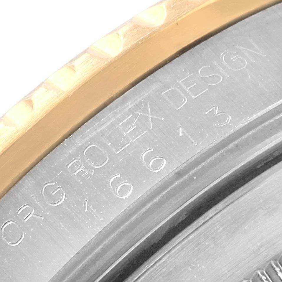 This close-up image shows the engraved case back edge of a Rolex Submariner 16613 Men's Steel and Gold (two tone) Blue Dial 16613 Men's Steel and Gold (two tone) Blue Dial, featuring the model number and design details.