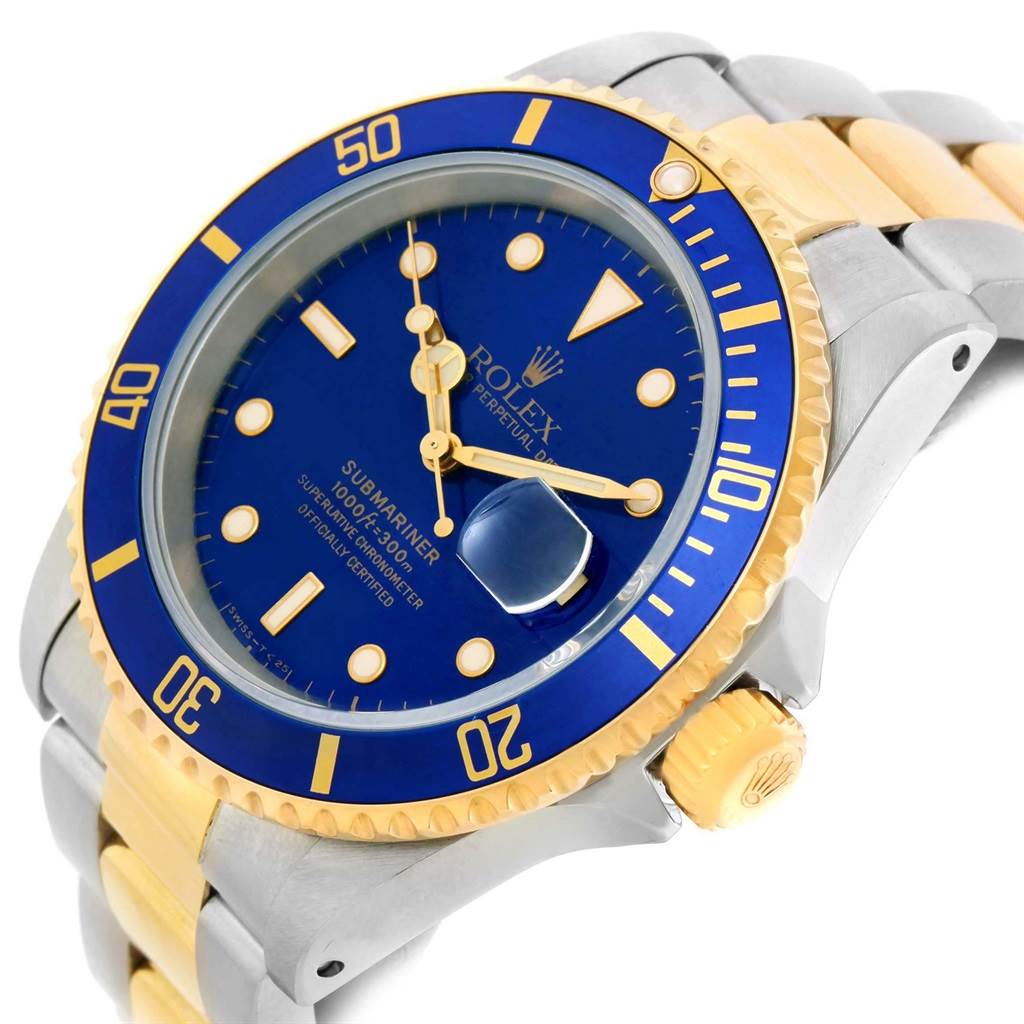 The image shows a Rolex Submariner 16613 Men's Steel and Gold (two tone) Blue Dial 16613 Men's Steel and Gold (two tone) Blue Dial watch from a three-quarter angle, highlighting its blue dial, bezel, and two-tone bracelet.