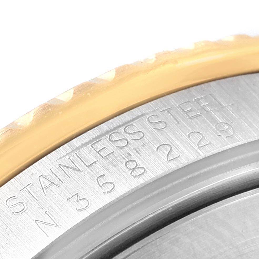 This close-up shot of the Rolex Submariner 16613 Men's Steel and Gold (two tone) Blue Dial 16613 Men's Steel and Gold (two tone) Blue Dial model shows the engraved "STAINLESS STEEL" and part of the bezel detail.