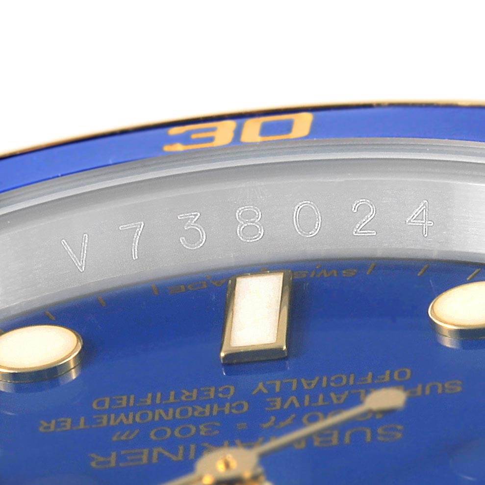 This image shows a close-up angle of the dial and bezel of a Rolex Submariner 116613 Men's Steel and Gold (two tone) Blue Dial 116613 Men's Steel and Gold (two tone) Blue Dial watch, revealing part of its serial number.