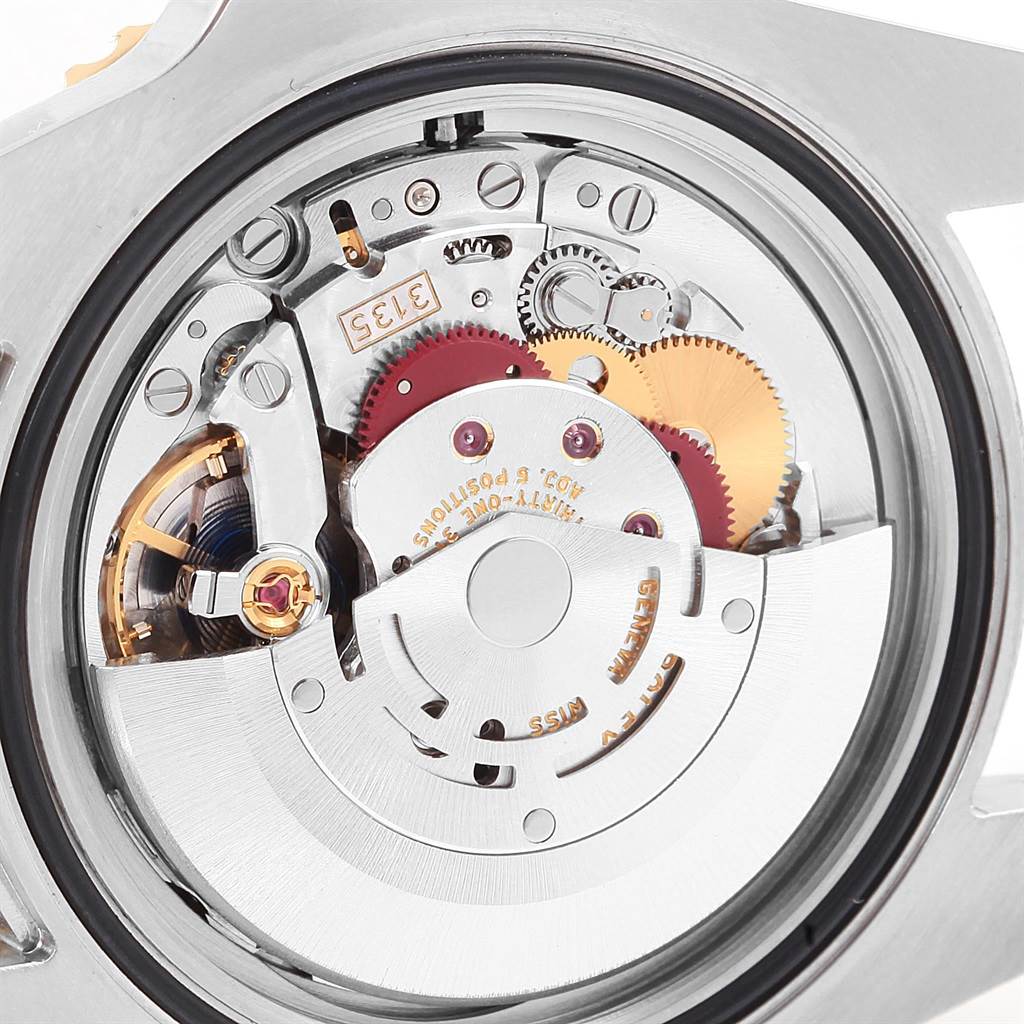 This image shows the detailed inner working watch mechanism of a Rolex Submariner 116613 Men's Steel and Gold (two tone) Blue Dial 116613 Men's Steel and Gold (two tone) Blue Dial from a back view.