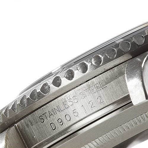 This image shows a close-up view of the side case and bezel of a Rolex Submariner 16610 Men's Stainless Steel Black Dial 16610 Men's Stainless Steel Black Dial, highlighting the engraved serial number and "STAINLESS STEEL."
