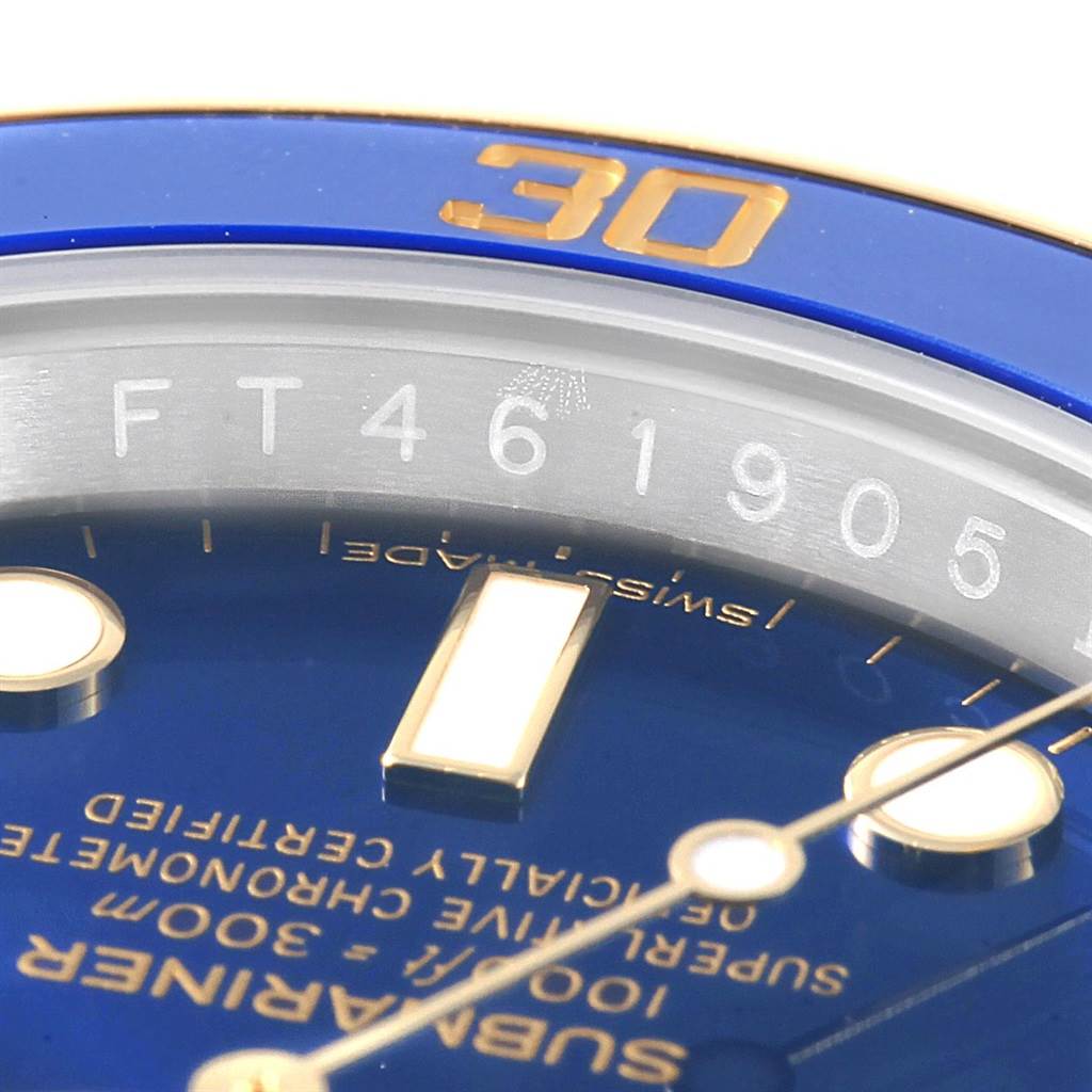 This close-up angle shows the dial, bezel, and part of the serial number of the Rolex Submariner 116613 Men's Steel and Gold (two tone) Blue Dial 116613 Men's Steel and Gold (two tone) Blue Dial.