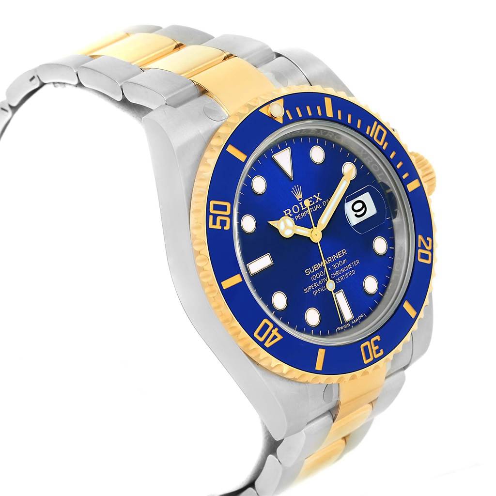 The image shows a Rolex Submariner 116613 Men's Steel and Gold (two tone) Blue Dial 116613 Men's Steel and Gold (two tone) Blue Dial watch at a three-quarter angle, highlighting the blue dial, gold bezel, and two-tone bracelet.