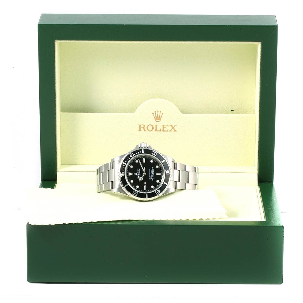 The Rolex Submariner 14060 Men's Stainless Steel Black Dial 14060 Men's Stainless Steel Black Dial watch is displayed in its open green box, showcasing its face and bracelet.