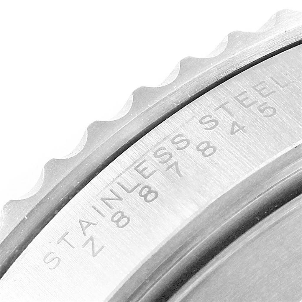 This close-up image displays part of the bezel and case back engraving of a Rolex Submariner 14060 Men's Stainless Steel Black Dial 14060 Men's Stainless Steel Black Dial watch.