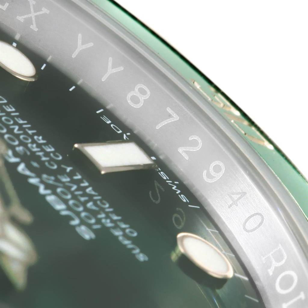 The image shows a close-up of the bezel and dial of a Rolex Submariner 116610LV Men's Stainless Steel Green Dial 116610LV Men's Stainless Steel Green Dial watch, focused on the numerals and part of the text.