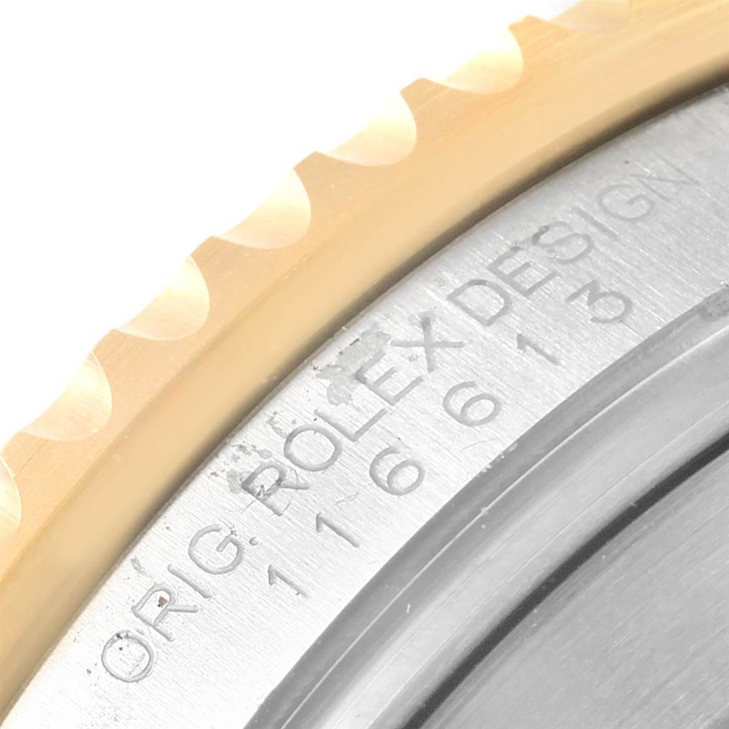 This image shows a close-up of the bezel and edge of the case back on a Rolex Submariner 116613 Men's Steel and Gold (two tone) Black Dial 116613 Men's Steel and Gold (two tone) Black Dial watch.