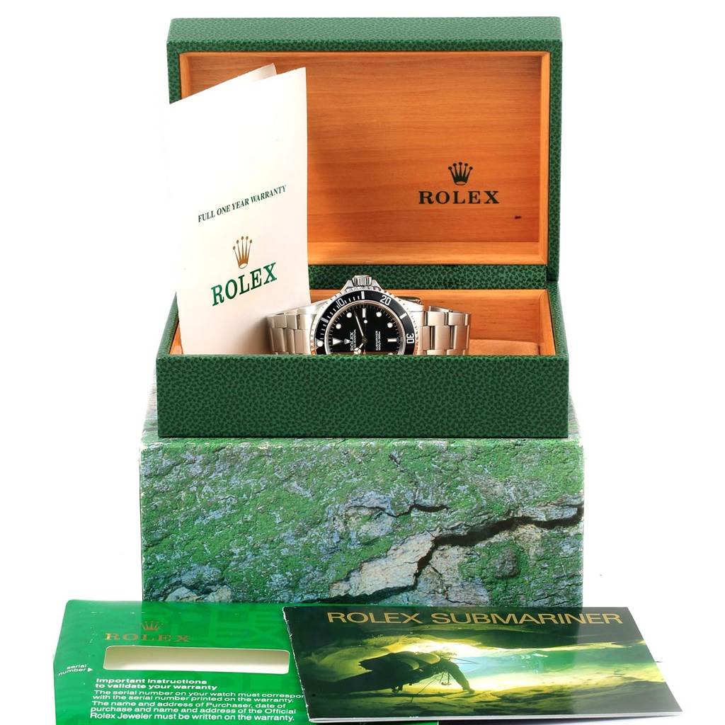 The image shows a Rolex Submariner 14060 Men's Stainless Steel Black Dial 14060 Men's Stainless Steel Black Dial watch in its box, along with warranty papers and an instruction manual.