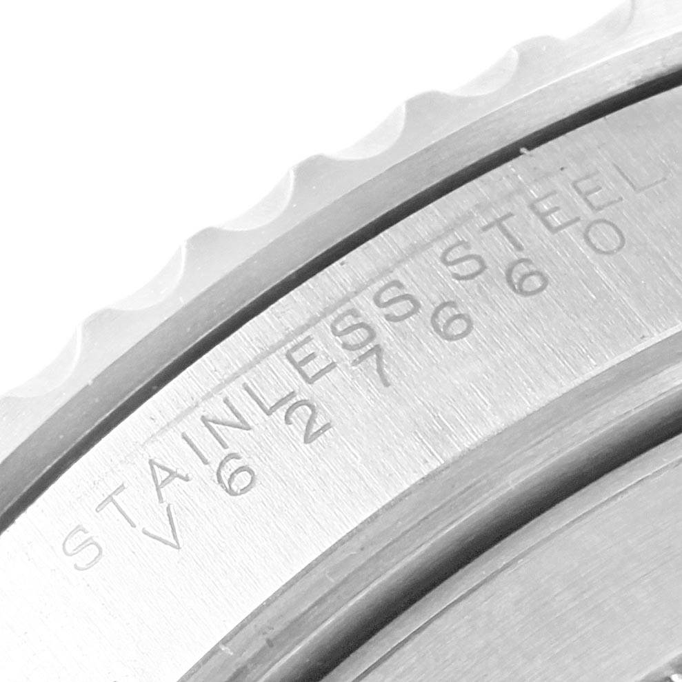 The image shows a close-up of the side of the bezel and the engraved back of a Rolex Submariner 14060 Men
s Stainless Steel Black Dial 14060 Men
s Stainless Steel Black Dial watch.