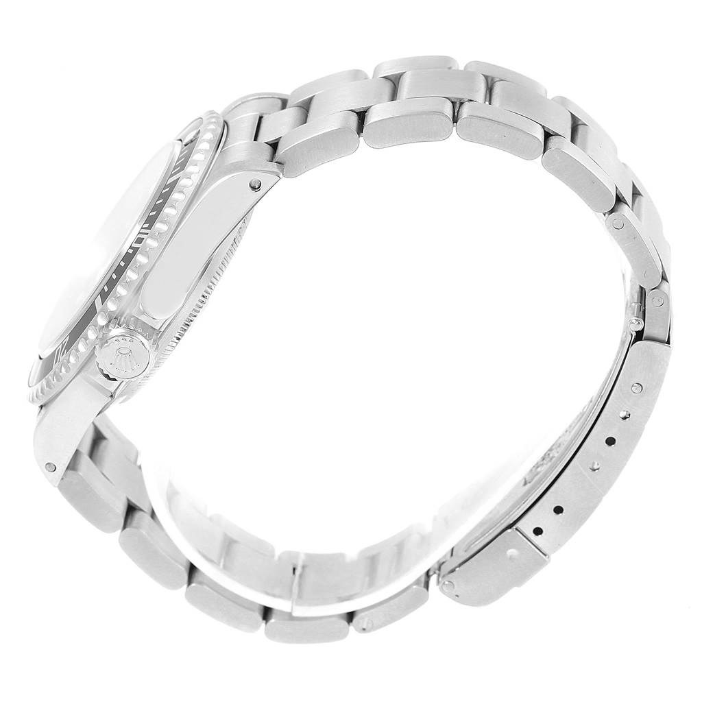 The Rolex Submariner 14060 Men
s Stainless Steel Black Dial 14060 Men
s Stainless Steel Black Dial watch is shown from the side, highlighting the crown and bracelet links.