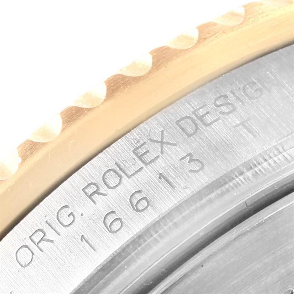 This close-up angle shows the engraved details on the bezel and case of the Rolex Submariner 16613 Men's Steel and Gold (two tone) Blue Dial 16613 Men's Steel and Gold (two tone) Blue Dial model 16613.