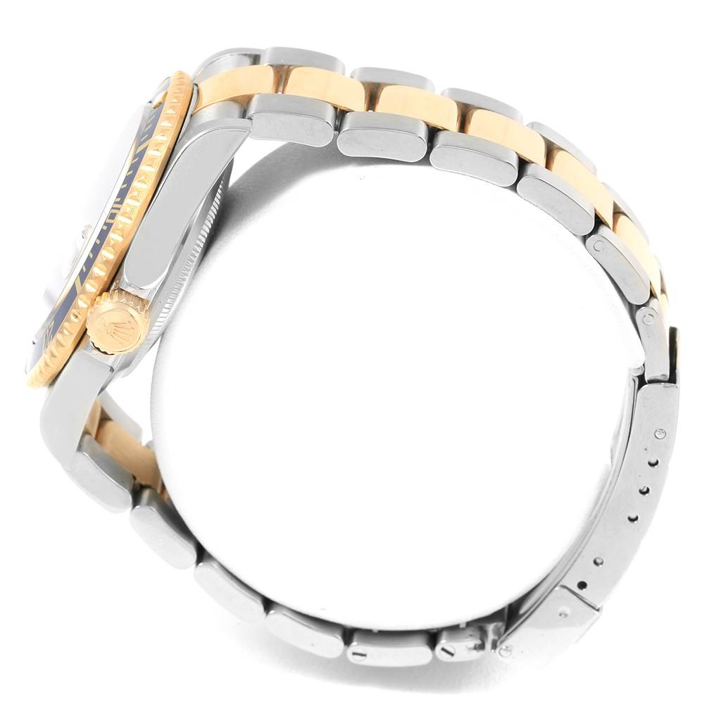 The image shows a side profile of the Rolex Submariner 16613 Men's Steel and Gold (two tone) Blue Dial 16613 Men's Steel and Gold (two tone) Blue Dial watch focusing on its bracelet and crown.