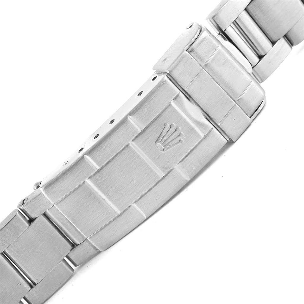 The image shows the clasp and part of the stainless steel bracelet of a Rolex Submariner 14060 Men's Stainless Steel Black Dial 14060 Men's Stainless Steel Black Dial watch.