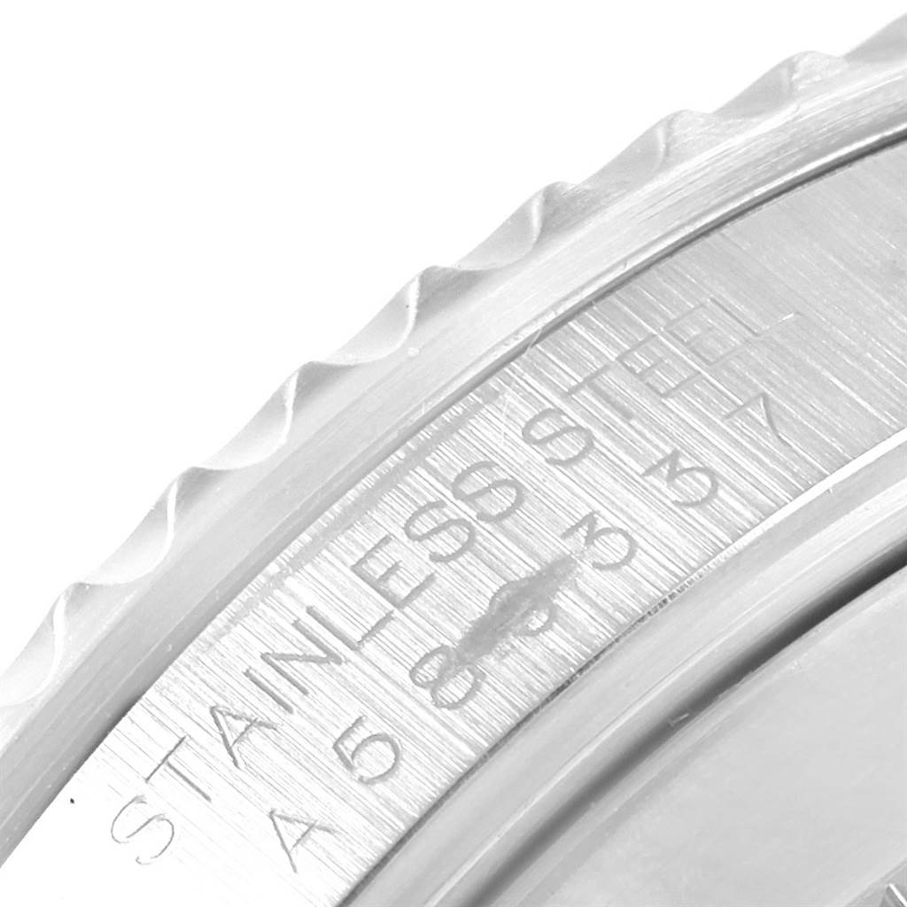 This image shows a close-up angle of the stainless-steel bezel and engraved text on a Rolex Submariner 14060 Men's Stainless Steel Black Dial 14060 Men's Stainless Steel Black Dial watch.