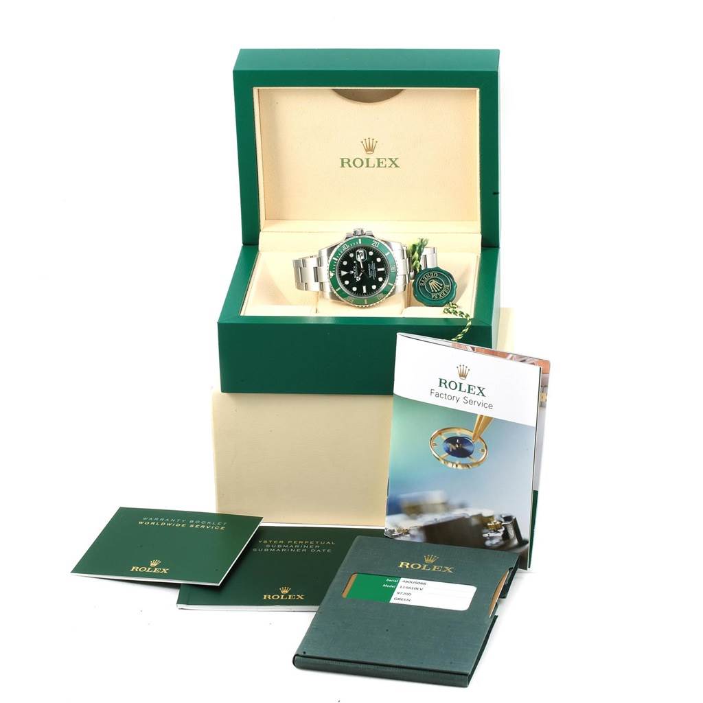 The image shows a Rolex Submariner 116610LV Men's Stainless Steel Green Dial 116610LV Men's Stainless Steel Green Dial watch in its green display box, alongside booklets, a tag, and the international guarantee card.