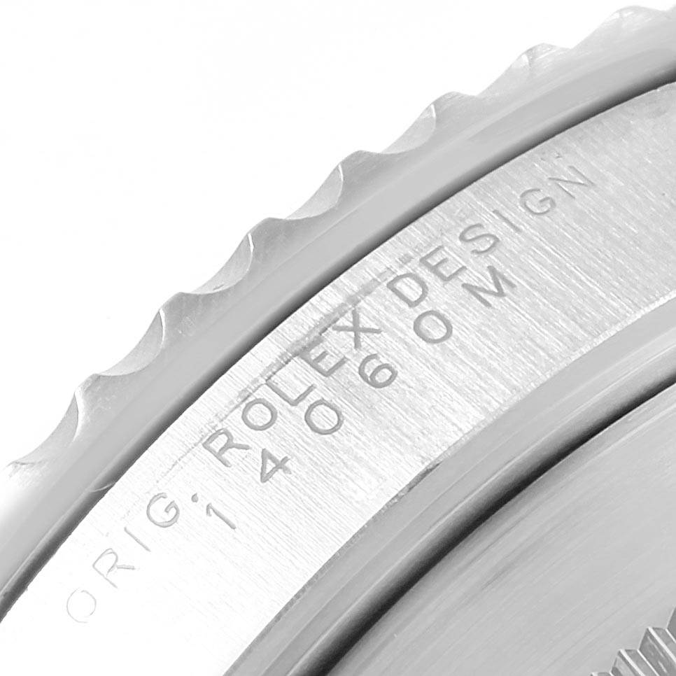 The image shows a close-up of the edge and engraving on the case back of a Rolex Submariner 14060 Men's Stainless Steel Black Dial 14060 Men's Stainless Steel Black Dial watch.