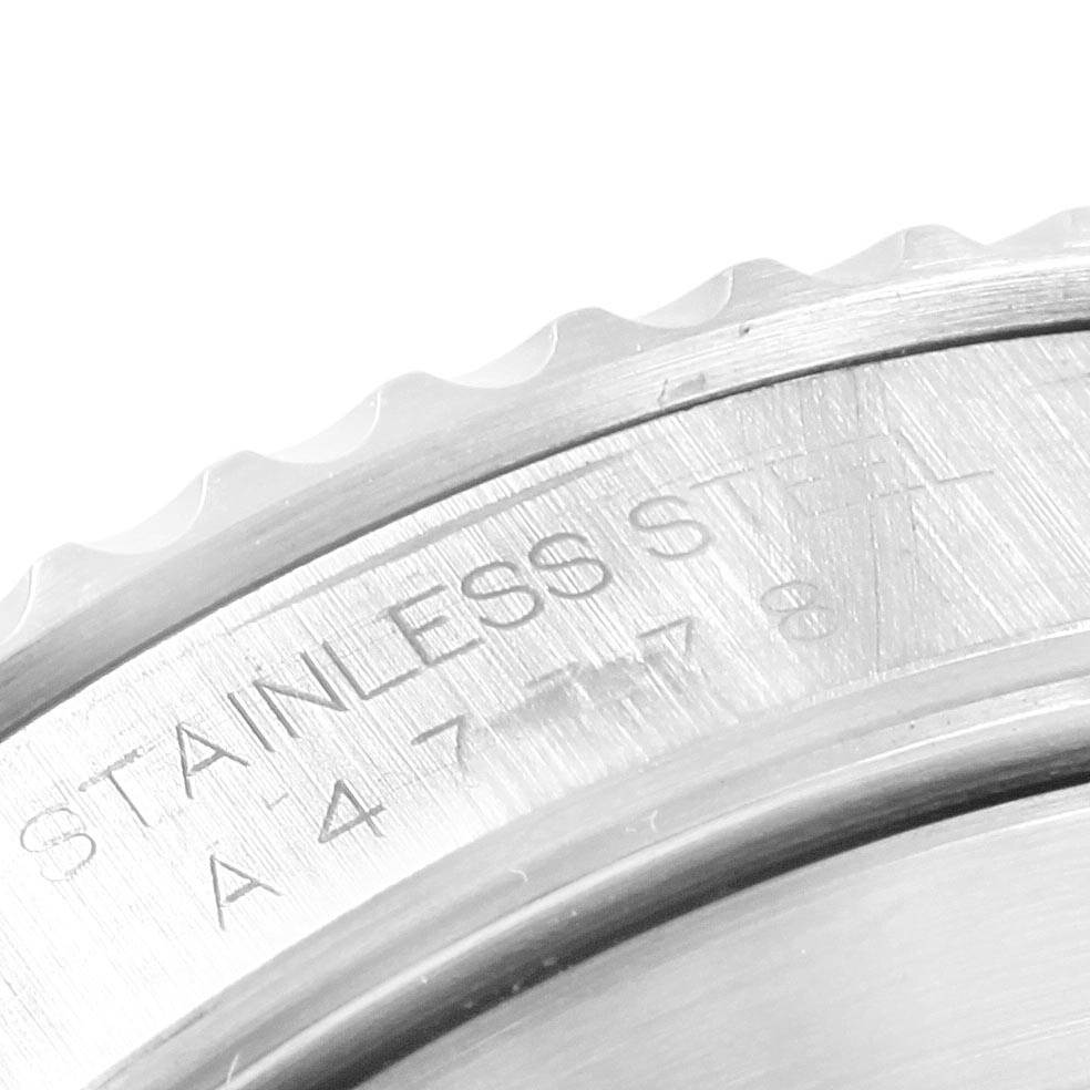 This close-up image shows the engraved text on the brushed stainless steel back of a Rolex Submariner 14060 Men's Stainless Steel Black Dial 14060 Men's Stainless Steel Black Dial watch.