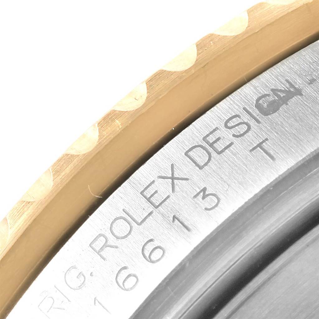 This image shows a close-up of the bezel and engraved case back edge of a Rolex Submariner 16613 Men's Steel and Gold (two tone) Champagne Dial 16613 Men's Steel and Gold (two tone) Champagne Dial watch.