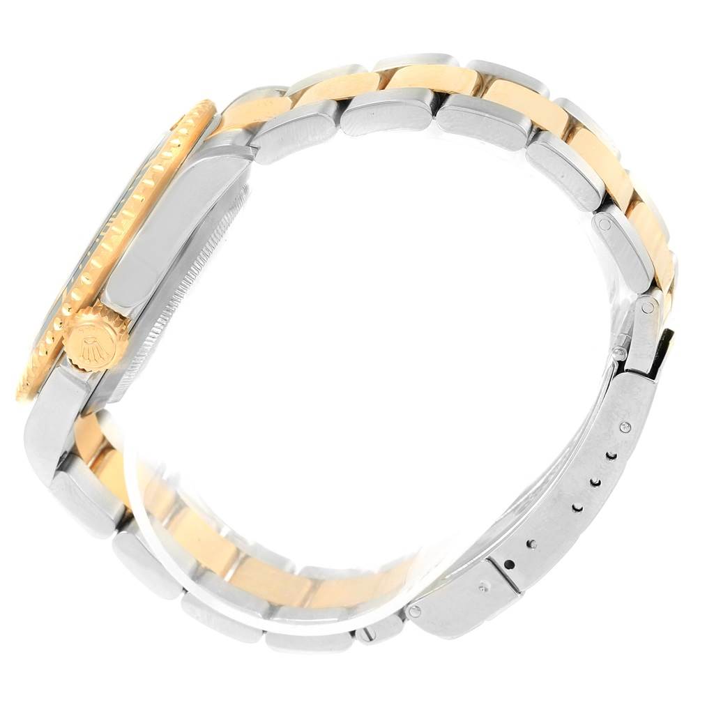 The image shows a side view of the Rolex Submariner 16613 Men's Steel and Gold (two tone) Champagne Dial 16613 Men's Steel and Gold (two tone) Champagne Dial watch, highlighting the crown, bezel, and two-tone bracelet.