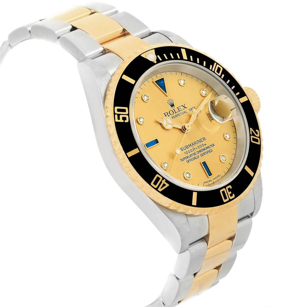 This Rolex Submariner 16613 Men's Steel and Gold (two tone) Champagne Dial 16613 Men's Steel and Gold (two tone) Champagne Dial watch is shown at an angle displaying its face, bezel, and part of the bracelet.