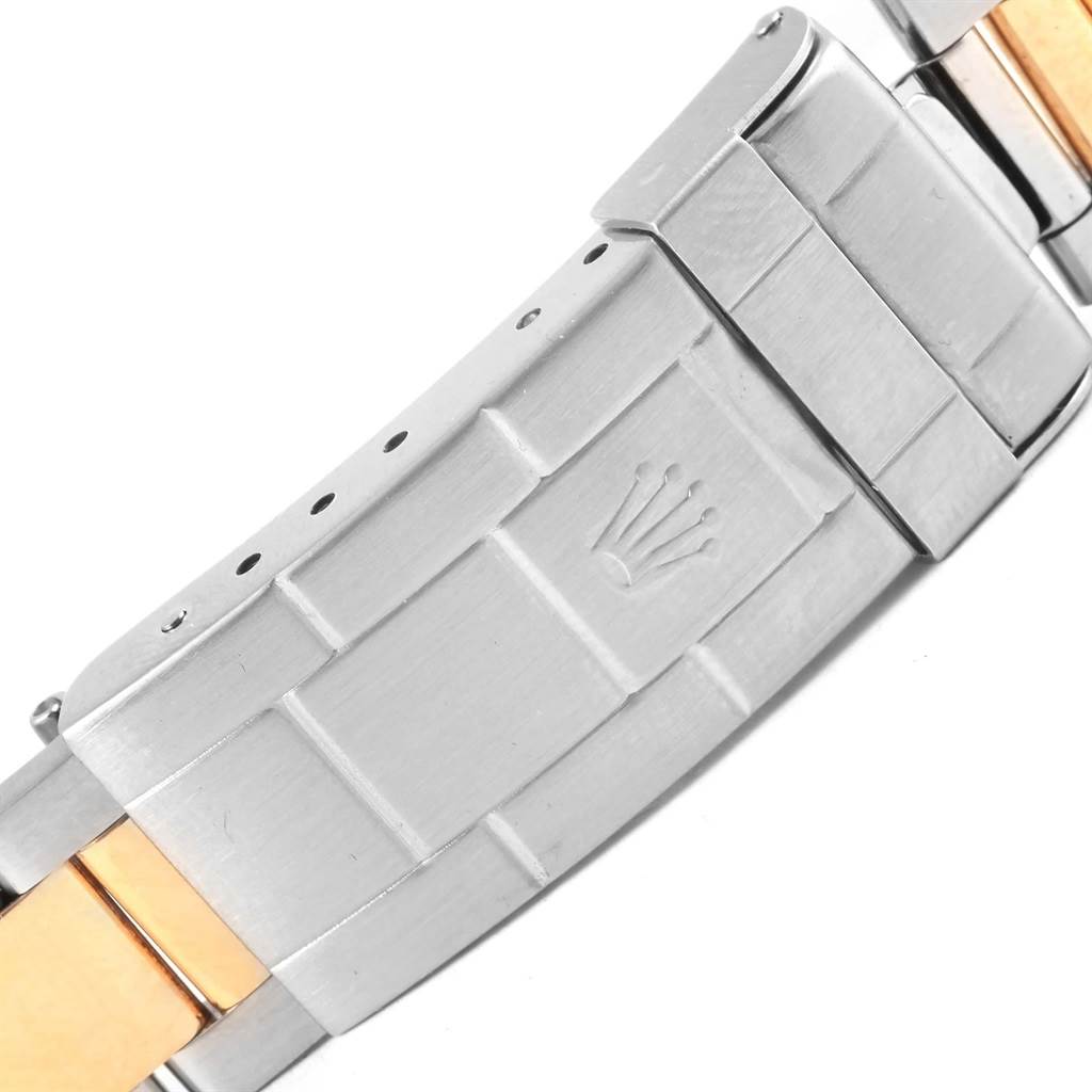 The image shows a close-up of the clasp of a Rolex Submariner 16613 Men's Steel and Gold (two tone) Blue Dial 16613 Men's Steel and Gold (two tone) Blue Dial watch, featuring a mix of silver and gold tones.