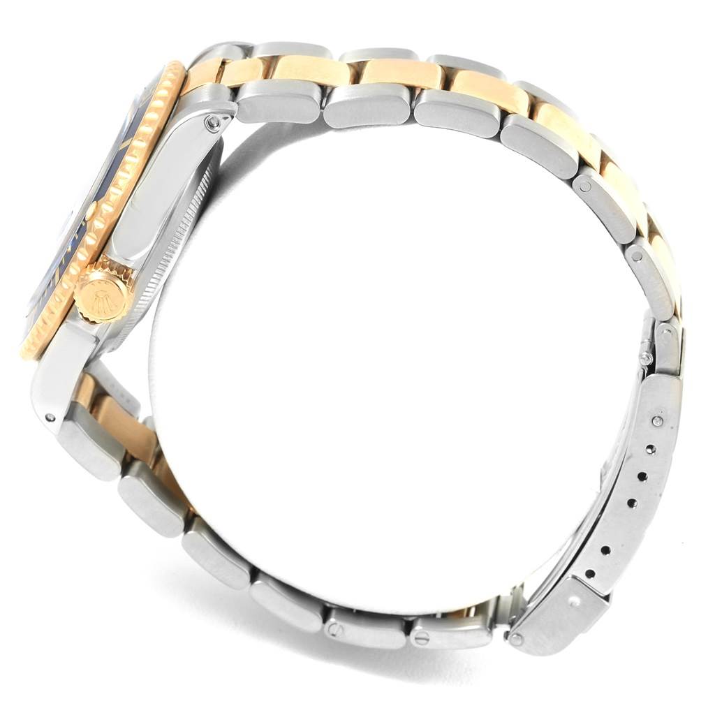 The image shows a side view of a Rolex Submariner 16613 Men's Steel and Gold (two tone) Blue Dial 16613 Men's Steel and Gold (two tone) Blue Dial watch, highlighting its two-tone bracelet and crown.