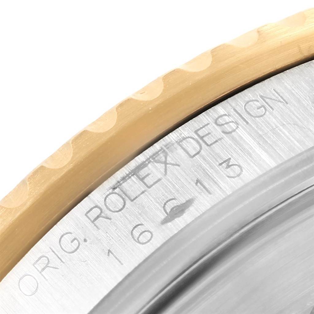 This close-up image shows the edge and engravings on the bezel and case of the Rolex Submariner 16613 Men's Steel and Gold (two tone) Blue Dial 16613 Men's Steel and Gold (two tone) Blue Dial watch.