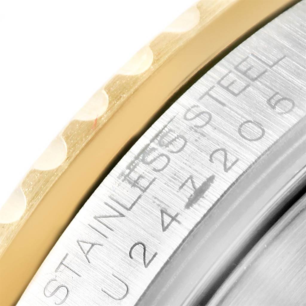 This image shows a close-up of the bezel and case side of a Rolex Submariner 16613 Men's Steel and Gold (two tone) Blue Dial 16613 Men's Steel and Gold (two tone) Blue Dial, highlighting the "STAINLESS STEEL" engraving.