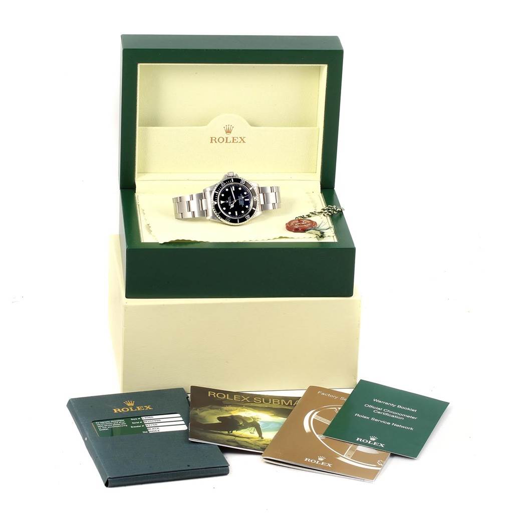 The image shows a Rolex Submariner 14060 Men's Stainless Steel Black Dial 14060 Men's Stainless Steel Black Dial watch in its open box, accompanied by manuals and a warranty card.