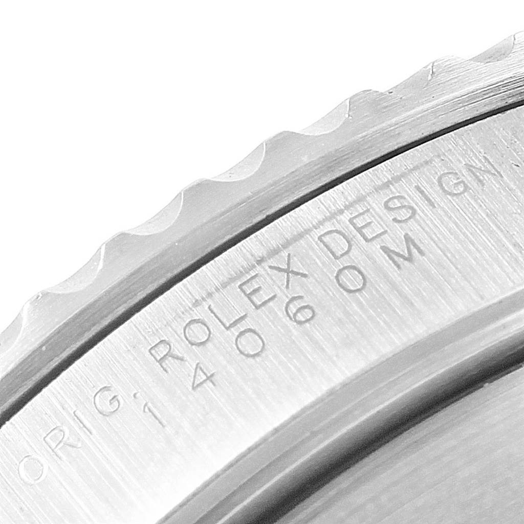 This close-up image shows the detailed edge and engraving on the bezel of a Rolex Submariner 14060 Men's Stainless Steel Black Dial 14060 Men's Stainless Steel Black Dial watch.