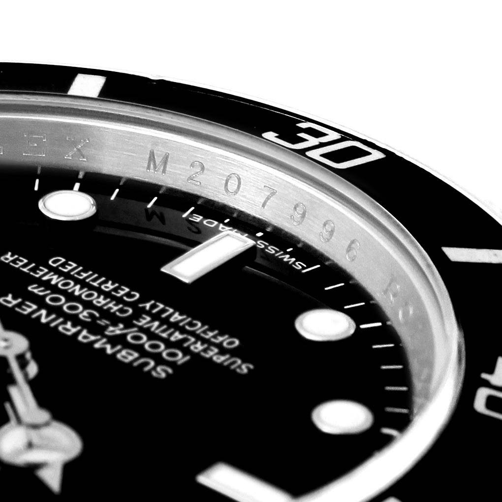 The image shows a close-up of the bezel and dial of the Rolex Submariner 14060 Men's Stainless Steel Black Dial 14060 Men's Stainless Steel Black Dial watch viewed at an angle, highlighting the serial number and markings.