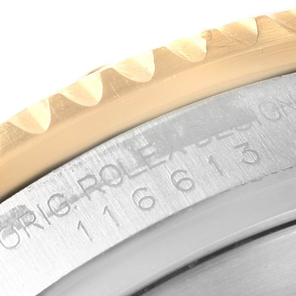 This image shows a close-up view of the bezel and engraved case of a Rolex Submariner 116613 Men's Steel and Gold (two tone) Blue Dial 116613 Men's Steel and Gold (two tone) Blue Dial watch.