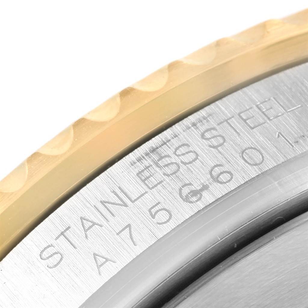 The image shows a close-up view of the stainless steel case back engraving and bezel of a Rolex Submariner 16613 Men's Steel and Gold (two tone) Black Dial 16613 Men's Steel and Gold (two tone) Black Dial watch.