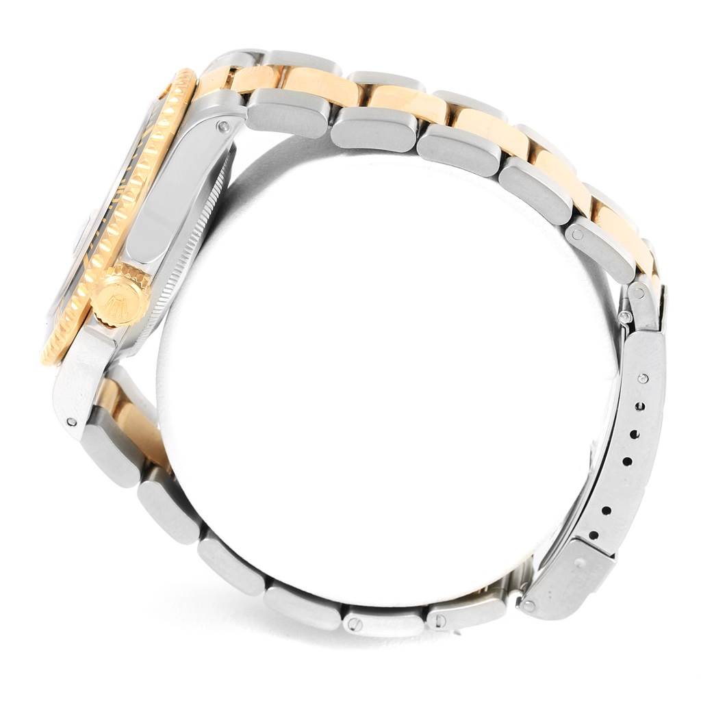 The image shows a Rolex Submariner 16613 Men's Steel and Gold (two tone) Black Dial 16613 Men's Steel and Gold (two tone) Black Dial watch from a side angle, highlighting its bezel, crown, and the two-tone bracelet.