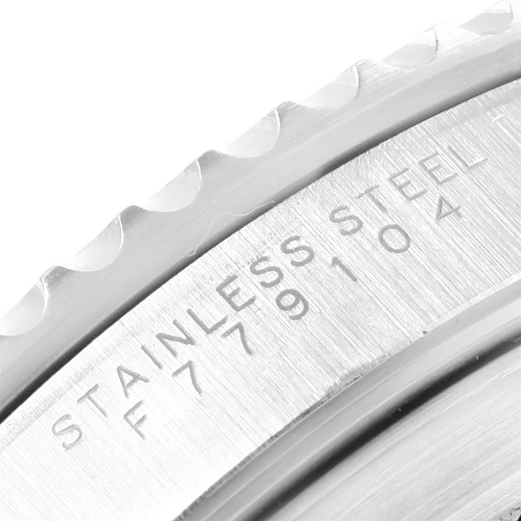 The image shows a close-up of the engraving on the stainless steel bezel of a Rolex Submariner 14060 Men's Stainless Steel Black Dial 14060 Men's Stainless Steel Black Dial watch.