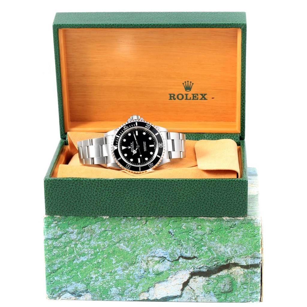 The image shows a Rolex Submariner 14060 Men's Stainless Steel Black Dial 14060 Men's Stainless Steel Black Dial watch displayed in an open green and orange Rolex box from a front angle.