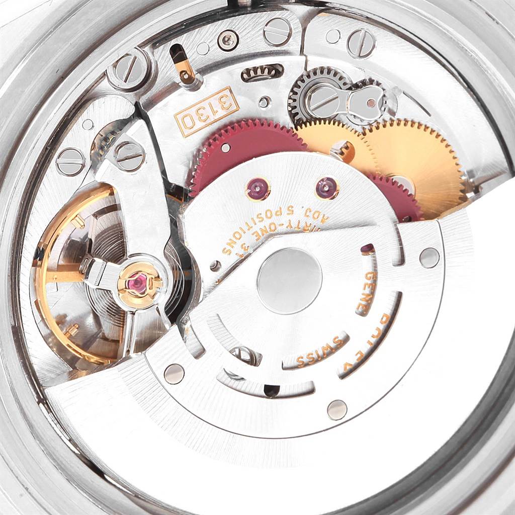 The image shows a close-up of the internal mechanism of a Rolex Submariner 14060 Men's Stainless Steel Black Dial 14060 Men's Stainless Steel Black Dial model watch, highlighting gears and components.