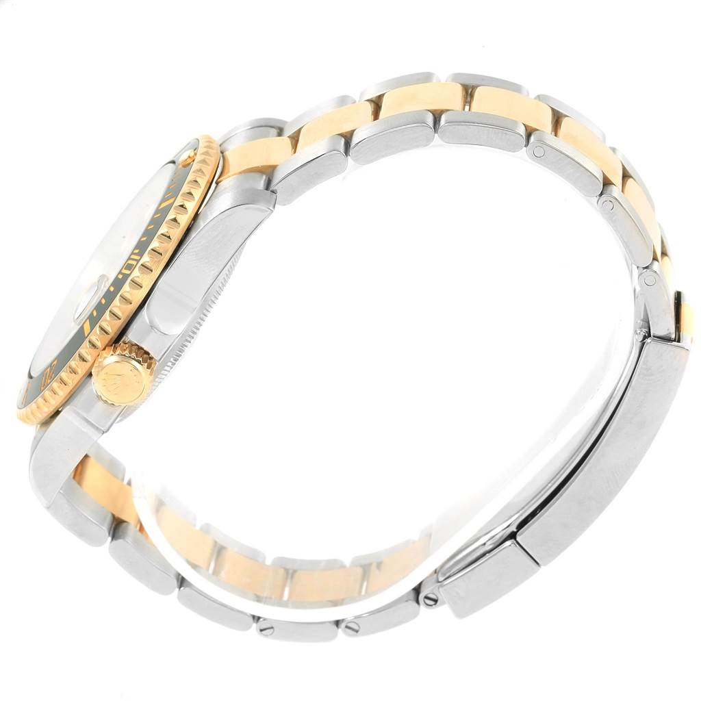 This side view of the Rolex Submariner 116613 Men's Steel and Gold (two tone) Black Dial 116613 Men's Steel and Gold (two tone) Black Dial watch shows the two-tone bracelet, the case, the crown, and part of the bezel.