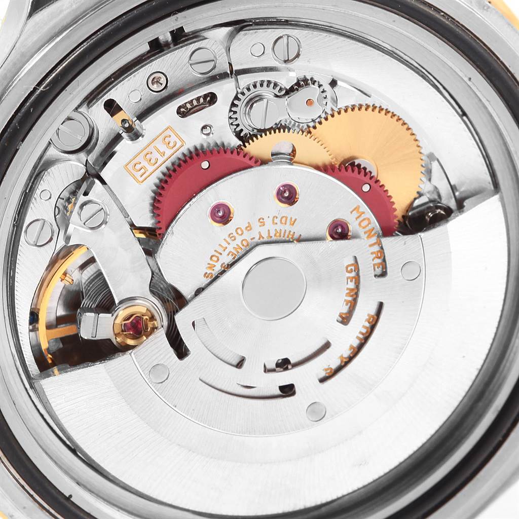 This image shows a close-up of the internal movement and gears of a Rolex Submariner 16613 Steel and Gold (two tone) Blue Dial 16613 Steel and Gold (two tone) Blue Dial watch from the back.