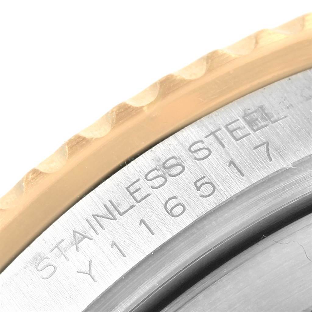 This image shows a close-up of the case back and part of the bezel of a Rolex Submariner 16613 Steel and Gold (two tone) Blue Dial 16613 Steel and Gold (two tone) Blue Dial, highlighting the stainless steel material and model number.