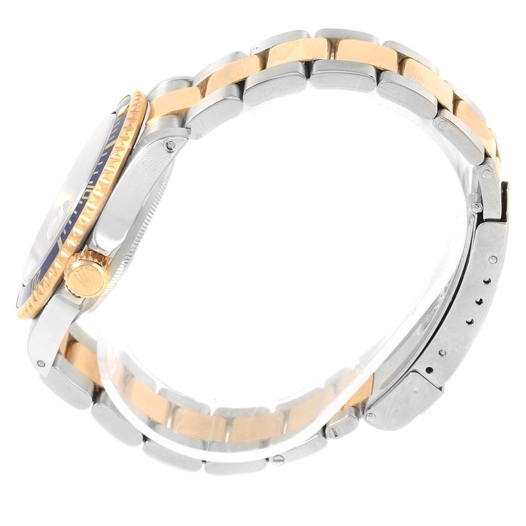 The image shows a side view of a Rolex Submariner 16613 Steel and Gold (two tone) Blue Dial 16613 Steel and Gold (two tone) Blue Dial watch, focusing on its case, bezel, and the two-tone bracelet.