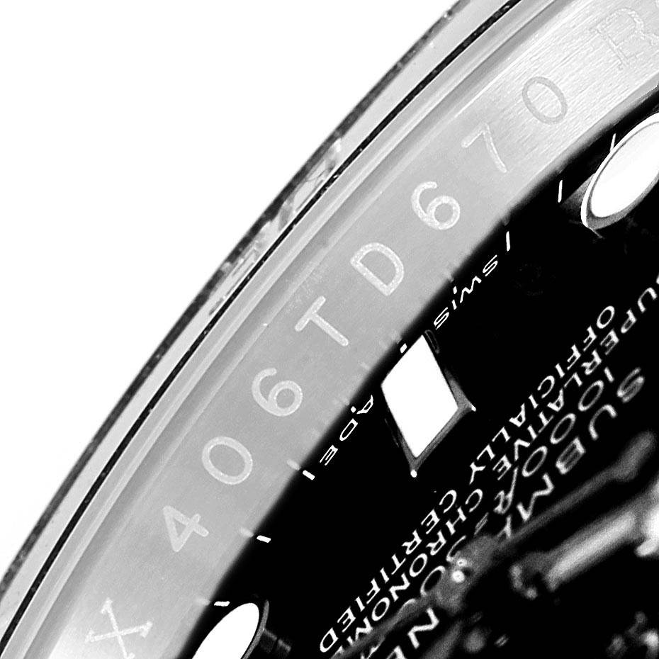 The image shows a close-up of the inner bezel and part of the dial of the Rolex Submariner 116610 Men's Stainless Steel Black Dial 116610 Men's Stainless Steel Black Dial watch, including some engraved serial numbers.