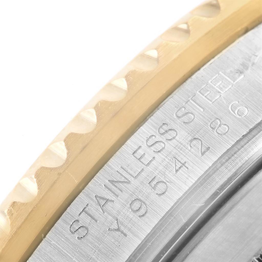 This image shows a close-up of the Rolex Submariner 16613 Men's Steel and Gold (two tone) Blue Dial 16613 Men's Steel and Gold (two tone) Blue Dial's stainless steel case and bezel.