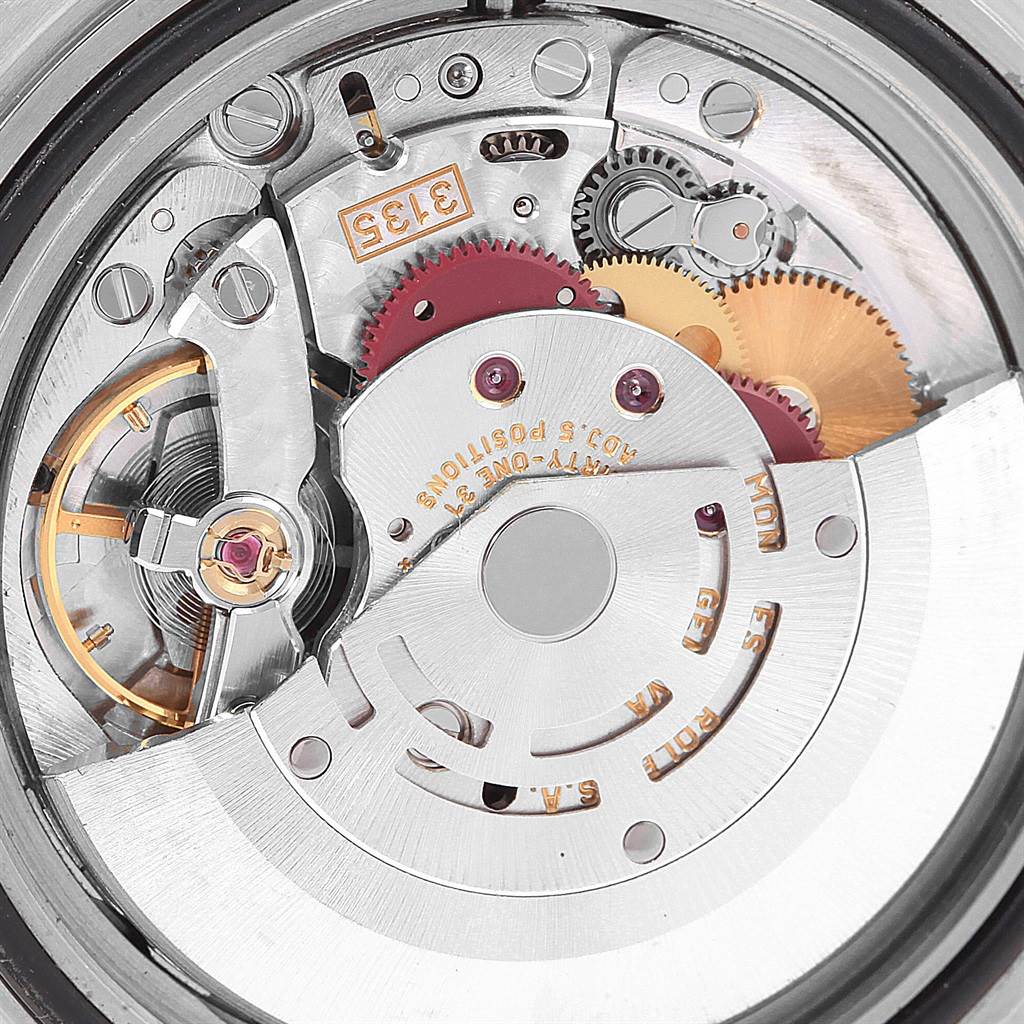 The image shows a close-up view of the internal mechanism of a Rolex Submariner 16613 Men's Steel and Gold (two tone) Blue Dial 16613 Men's Steel and Gold (two tone) Blue Dial model watch, highlighting its gears and components.