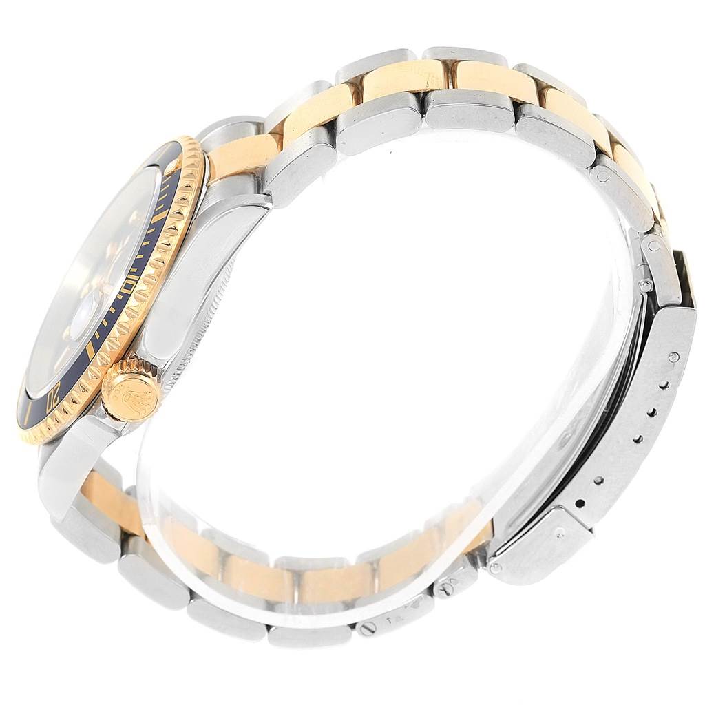 This side view of the Rolex Submariner 16613 Men's Steel and Gold (two tone) Blue Dial 16613 Men's Steel and Gold (two tone) Blue Dial shows the band and the case with a focus on the crown and bezel.