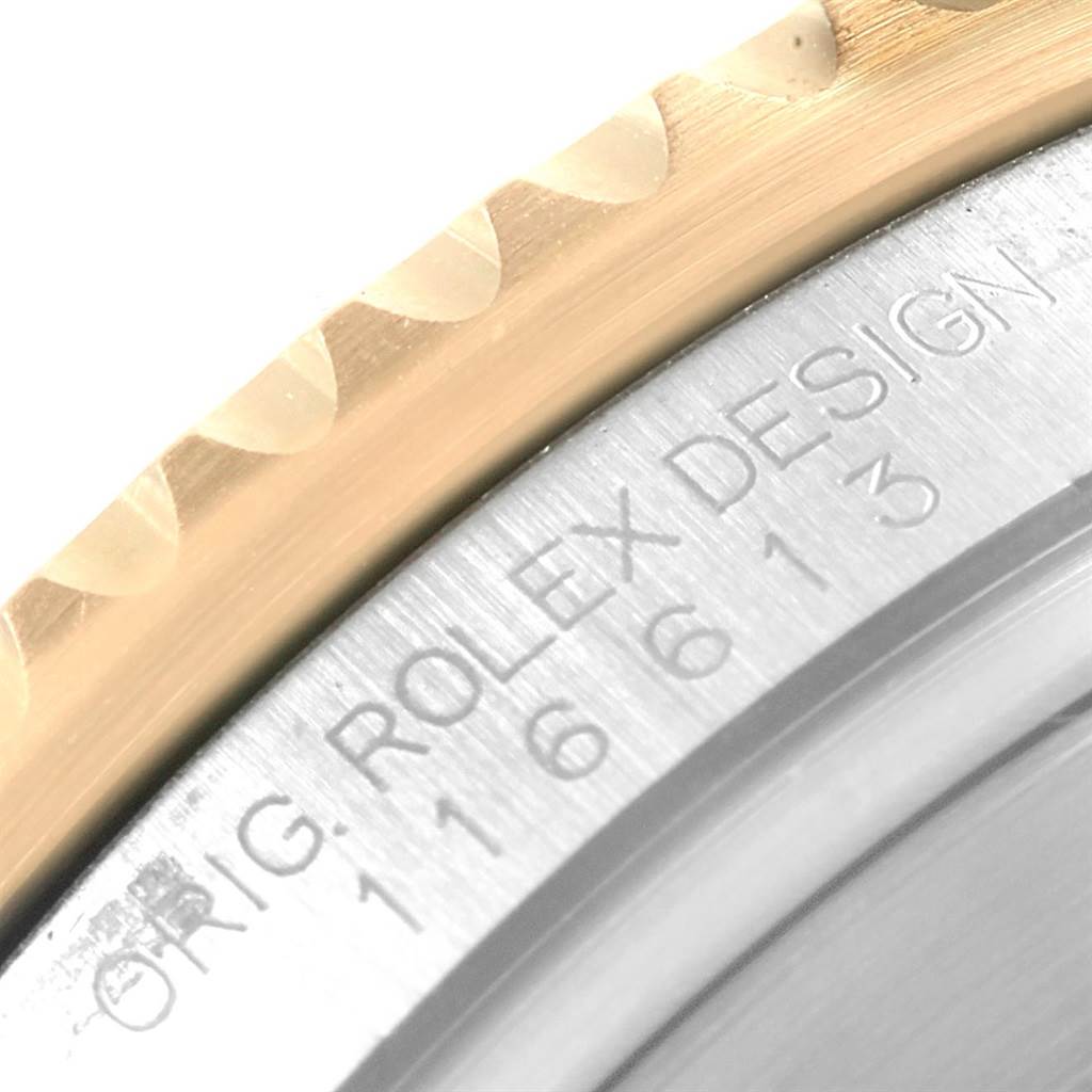 The image shows a close-up of the bezel and case back of a Rolex Submariner 116613 Men's Steel and Gold (two tone) Blue Dial 116613 Men's Steel and Gold (two tone) Blue Dial, highlighting its engraved model number.